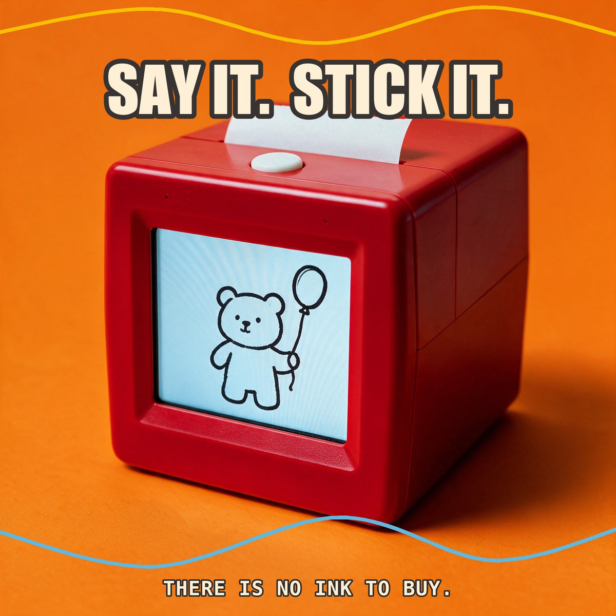 A red cube sticker printer on orange with the words say it stick it